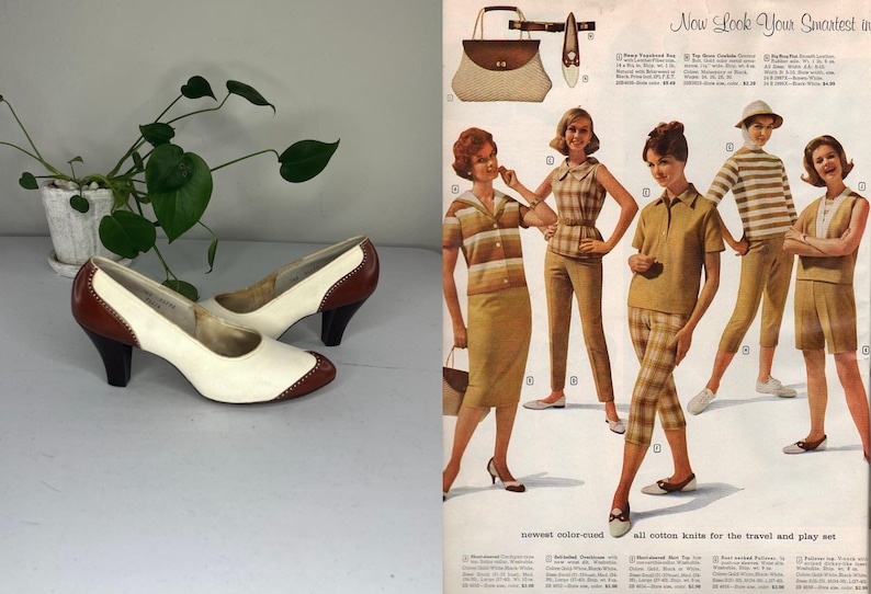 May include: A pair of vintage women's pumps with a two-tone design. The shoes feature a cream-colored body with brown accents on the heel and toe. The heels are approximately 3 inches high. The image also includes a vintage fashion advertisement.