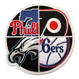 May include: A circular patch featuring the logos of four Philadelphia sports teams. The patch is divided into quadrants, with the Phillies, Flyers, Eagles, and 76ers logos displayed in red, black, white, and blue.