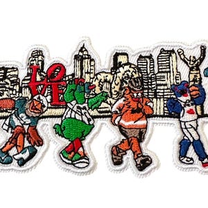 May include: Embroidered patch featuring cartoon mascots in sports uniforms, with the word "LOVE" and a city skyline. The mascots are in various colors, including orange, green, and blue. The patch has a white border.