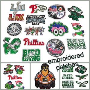 K&ouml;nnte beinhalten: Eine Sammlung gestickter Aufn&auml;her mit Logos und Texten zu den Sportteams von Philadelphia. Die Aufn&auml;her zeigen die Eagles, Phillies und 76ers in verschiedenen Designs und Farben. Die W&ouml;rter "gestickt" und "Aufn&auml;her" sind ebenfalls sichtbar.