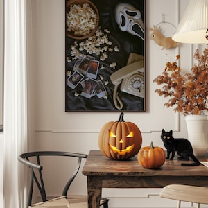 May include: A Halloween still life with a carved pumpkin, a smaller pumpkin, and a black cat on a wooden table. A framed picture on the wall shows popcorn, a Scream mask, and vintage photos. The scene evokes a spooky atmosphere.