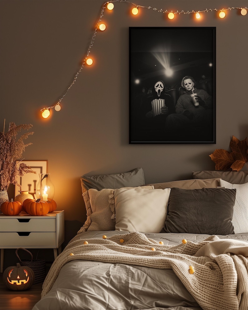 May include: A Halloween-themed bedroom scene with a framed black and white movie poster featuring characters in a theater. The room is decorated with string lights, pumpkins, and a carved jack-o'-lantern. The bed is made with gray bedding and decorative pillows.