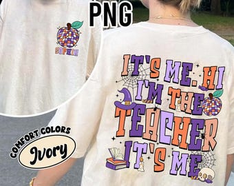May include: Ivory-colored t-shirt with a colorful graphic on the front and back. The front features a disco ball apple design with the name "Sophia". The back says "It's Me, Hi, I'm The Teacher, It's Me" with Halloween-themed graphics.