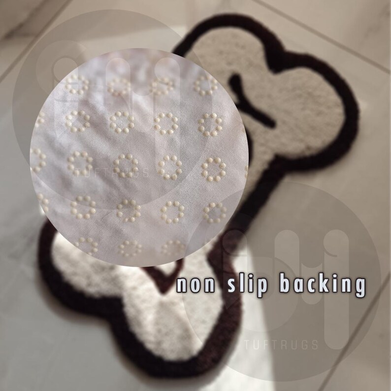 May include: A white bone-shaped rug with a brown outline. The rug has a non-slip backing with small white dots.