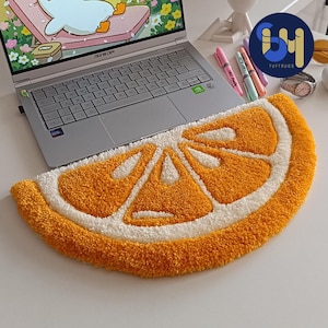 May include: A yellow and white orange slice shaped rug. The rug is made of fluffy material and is perfect for adding a touch of whimsy to any room.
