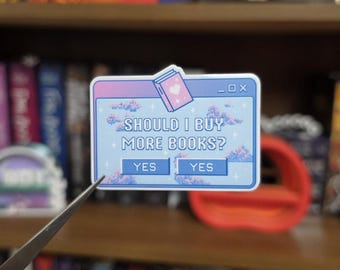 Könnte beinhalten: Ein rechteckiger Aufkleber im Design eines Computer-Pop-up-Fensters mit hellblauem Hintergrund, der mit verpixelten Wolken und Sternen verziert ist. Der Text lautet SHOULD I BUY MORE BOOKS? mit zwei Schaltflächen darunter, die beide YES zeigen.