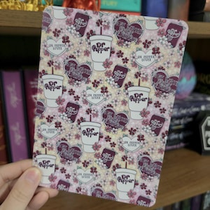 May include: A rectangular sign featuring a repeating pattern of Dr. Pepper cups, soda cans, and heart-shaped text bubbles that read Dr. Pepper Lover and Save Water Drink Dr. Pepper, all accented with small pink and white flowers on a light background.