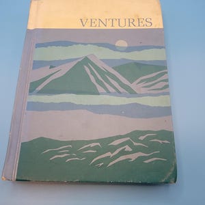 May include: A hardcover book titled VENTURES with a dust jacket featuring a stylized landscape illustration. The cover displays layered green and blue mountains under a pale circular sun against a light cream and blue background.