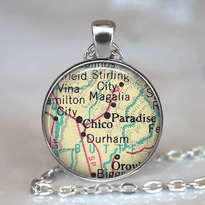 May include: A white ceramic mug with a black handle and the text "But First, Coffee" in a bold, black font. The mug is set against a blurred background, suggesting a cozy setting.