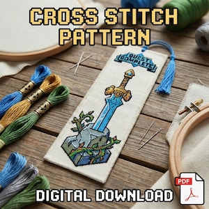 May include: A cross stitch pattern bookmark featuring a pixelated sword design, with the text "QUEST COMPLETE". The image includes embroidery floss in blue, gold, and green, needles, and a wooden embroidery hoop. The words "CROSS STITCH PATTERN" and "DIGITAL DOWNLOAD" are also visible.