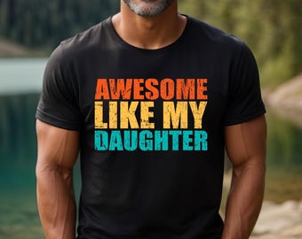 May include: Black t-shirt with a vintage-style graphic that reads "Awesome Like My Daughter" in orange, yellow, and blue.