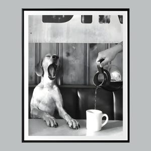 May include: Black and white photograph of a dog yawning at a table. A hand pours coffee from a black pot into a white mug. The dog is sitting at a table in a diner setting.