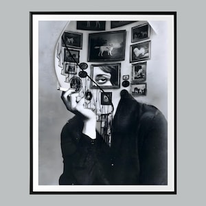 May include: A black and white photo of a woman with a staircase and framed pictures behind her. The woman is holding a cigarette and looking away from the camera.
