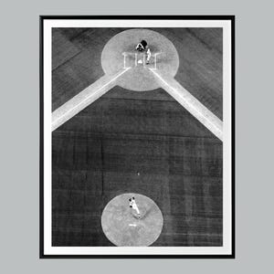 May include: Monochrome framed print depicting a baseball game from above. The image shows the pitcher, batter, and catcher at the plate, with the infielder in the distance. The field is marked with white lines.