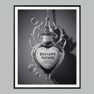 May include: Black and white framed print featuring a heart-shaped potion bottle with the words "SELF-LOVE POTION. DRINK IT EVERY DAY." The bottle is suspended by a chain and surrounded by bubbles, creating a whimsical and enchanting aesthetic.