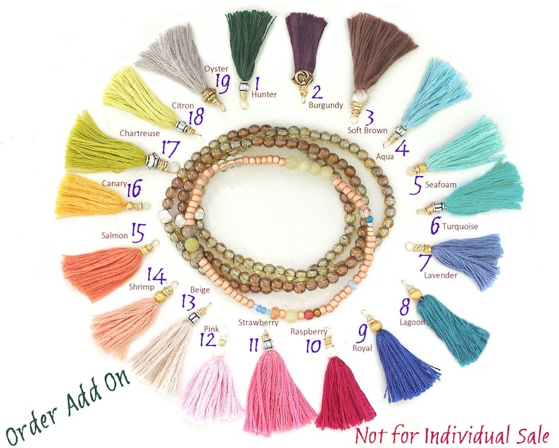May include: A selection of 19 colorful tassel charms with numbers 1 through 19. The tassels are arranged in a circle around a beaded bracelet. The bracelet is made of brown, beige, and green beads. The tassels are made of various colors, including red, pink, orange, yellow, green, blue, purple, and brown. The tassels are all about 2 inches long. Not for individual sale.