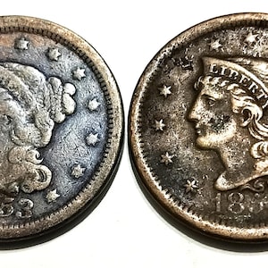 May include: Two antique silver coins. The coins feature a profile of a woman with the word "LIBERTY" above her head. The year 1853 is visible on one coin, and 1854 on the other. Both coins are surrounded by stars.