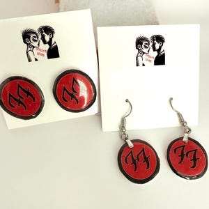 Foo fighters logo earrings comes in studs or dangle!  The  size of a nickel. Gift box included!