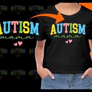 Puede incluir: Camiseta negra con las palabras "AUTISM mama" en letras coloridas. La palabra "AUTISM" está en amarillo, rosa, verde y azul. Dos corazones rosas están debajo de la palabra "mama".