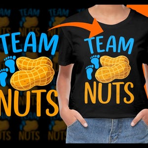 May include: A black t-shirt with the text "Team Nuts" in blue and orange. The text is accompanied by a graphic of two peanuts and two blue footprints.