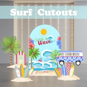 May include: Colorful surf-themed cutouts with the text "Surf Cutouts". The scene includes a blue arch with a sun and the text "Catch a Wave", a shark, palm trees, surfboards, a beach hut, and a blue and white van.