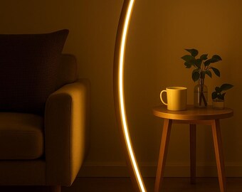 May include: A modern, curved wooden floor lamp with a warm, glowing light. The lamp has a rectangular base and a slender, arched design. A small side table with a mug and plants sits nearby, creating a cozy ambiance.