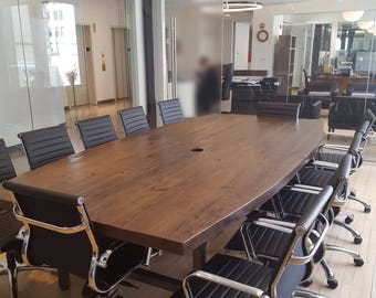 Office Meeting Table made with reclaimed wood 2.5 inches thick in boat shape and steel H frame legs.  Custom projects and designs welcome.