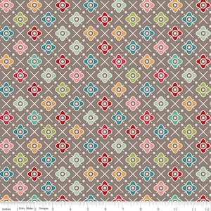 May include: A repeating pattern of colorful floral shapes in red, pink, green, blue, and orange, set against a brown background. The flowers are arranged in a grid with white crosshatch lines and small white dots. The fabric is 12 inches wide.