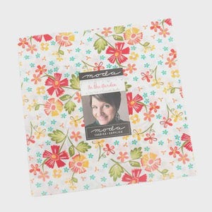May include: A square fabric bundle with a floral pattern in red, yellow, and orange on a white background. The fabric is labeled "In the Garden" with a photo of a woman and the Moda Fabrics logo.