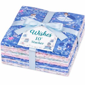 May include: A stack of fabric squares, tied with a light blue ribbon and bow. The fabric has a blue floral pattern with images of a princess. A tag reads "Wishes 10" Stacker".