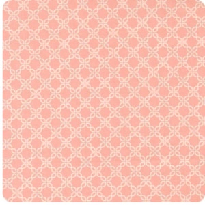 May include: Square, peach-colored fabric with a repeating pattern of white, interconnected floral shapes. The design creates a lattice-like effect, offering a delicate and visually appealing texture. The overall aesthetic is soft and feminine.