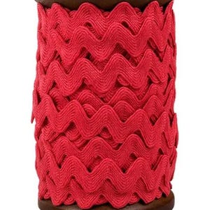 May include: A spool of bright red zigzag ribbon. The ribbon is tightly wound around a dark brown wooden spool. The ribbon's wavy design creates a textured appearance, perfect for crafting and embellishments.
