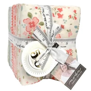 May include: A stack of floral fabric squares tied with a white ribbon printed with measurements. The fabric features a cream background with pink, red, and green floral patterns. A tag with the words "moda FABRICS-SUPPLIES" is attached to the ribbon.