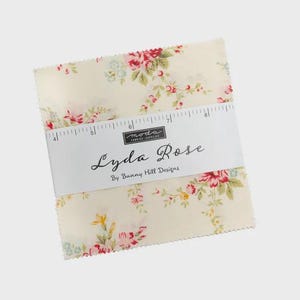 May include: A stack of cream-colored fabric squares with a floral pattern of red, pink, and yellow roses and green leaves. The fabric is labeled "Lyda Rose" by Bunny Hill Designs.