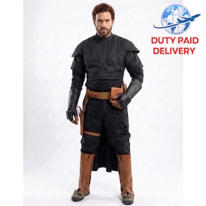 May include: A black costume with a high collar, shoulder pads, and long sleeves. The outfit includes black pants, brown boots, a brown belt, and a holster. The image also includes the text "DUTY PAID DELIVERY".
