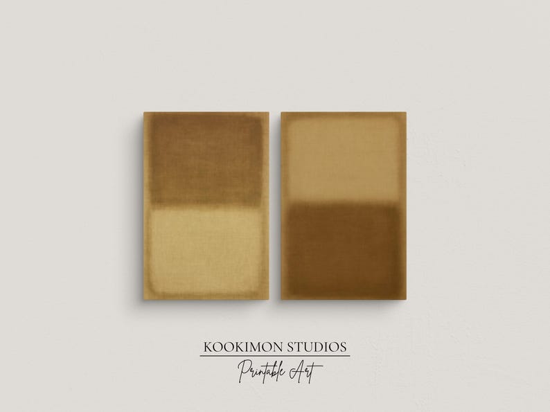 A minimalist room with a soft gray wall. On the wall, two framed abstract prints, Amber & Dawn Divide Set—glow in warm ochre and golden tones on natural linen. The diptych brings balance, calm, and understated elegance to the serene Japandi-style space filled with natural light.