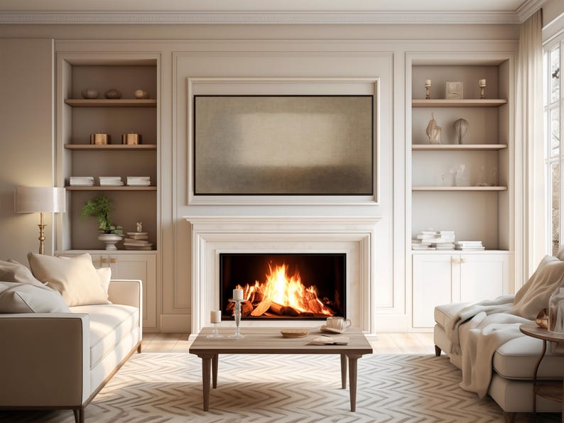 A refined living room with a glowing fireplace, neutral furnishings, and built-in shelving styled with ceramics and books. Soft natural light and beige tones create a warm, elegant atmosphere. Above the mantel, the Samsung Frame TV features soft beige and earth-toned layers with a diffused central form and subtle textured surface. Designed for Frame TV, this neutral artwork creates a calm, gallery-style presence on a television, blending naturally into modern, Japandi, and minimalist interiors.