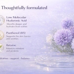 May include: A soft, light purple image with text describing skincare ingredients. The text includes "Low Molecular Hyaluronic Acid", "Panthenol (B5)", and "Betaine". The image also features purple flowers and a clear, round dish.