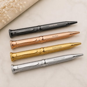 May include: Four metal ballpoint pens with a textured crosshatch pattern and a smooth clip. The pens are finished in black, rose gold, gold, and silver. Each pen is engraved with a name: David Smith, Ava Rose, Palette Visuals, and Mathew Kavin.