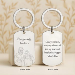May include: Two silver-toned metal dog tag keychains with circular rings. The front tag features an engraved line drawing of two people with the text I love you daddy Frankie x. The back tag features the engraved text Dad, you are my hero.