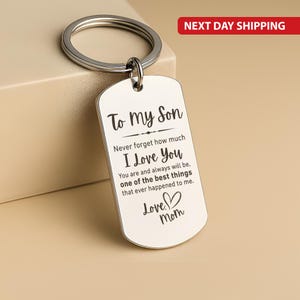 May include: Silver-colored dog tag keychain with the text "To My Son" and a heartfelt message from "Mom". The keychain has a split ring for attaching keys.