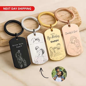May include: Four rectangular metal keychains in black, silver, gold, and rose gold finishes. Each features a circular ring and custom laser-engraved illustrations of people with text including Drive Safe Dad, Daddy, Happy Birthday DADDY, and Daddy's Girl.