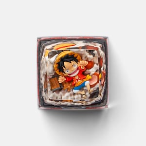 May include: A square-shaped artisan keycap featuring a colorful anime character in a dynamic pose. The keycap has a layered design with a red, white, and brown color scheme, and is likely made of resin.