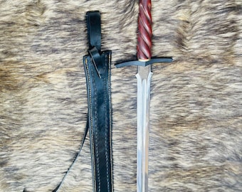 May include: A silver sword with a red and black handle and a black leather scabbard with a strap.