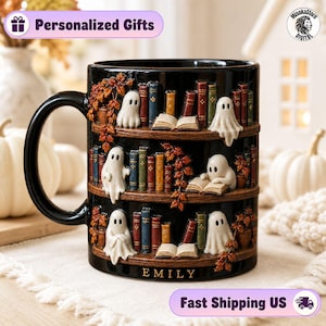 May include: A black ceramic mug featuring a three-tiered bookshelf design with white ghosts, colorful books, and autumn leaves. The mug includes an open book on each shelf and the name EMILY printed in gold lettering at the base of the mug.