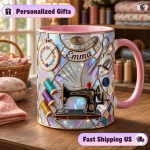 May include: A ceramic mug with a pink interior and handle, featuring an iridescent stained-glass style pattern. The design includes a black sewing machine, a measuring tape with the name Emma, scissors, needles, thread spools, and buttons.