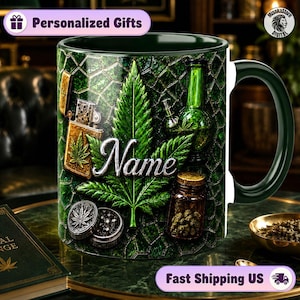 Puede incluir: Una taza de cerámica verde oscuro con un patrón de vidrieras repetitivo. El diseño incluye una hoja de cannabis central, un encendedor metálico, una pipa de agua de vidrio verde, un frasco pequeño de hierbas secas y un molinillo. La palabra Name es plateada.