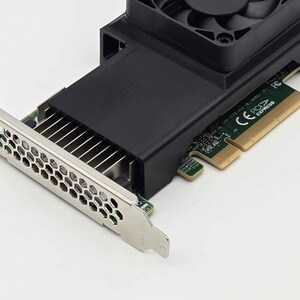 May include: A black computer component with a silver metal bracket and a black fan. The component has a series of metal fins and a green circuit board. The fan is located at the top of the component.