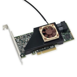 May include: A green printed circuit board expansion card featuring a black plastic shroud and a small brown cooling fan. The card includes a metal mounting bracket, a PCI Express interface, and a black cable extending from the top edge.