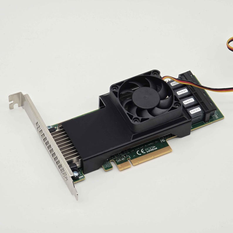 May include: A computer component, a black and green PCI Express card with a cooling fan. The card has a silver bracket and multiple ports. The fan is black and sits atop a black heatsink.